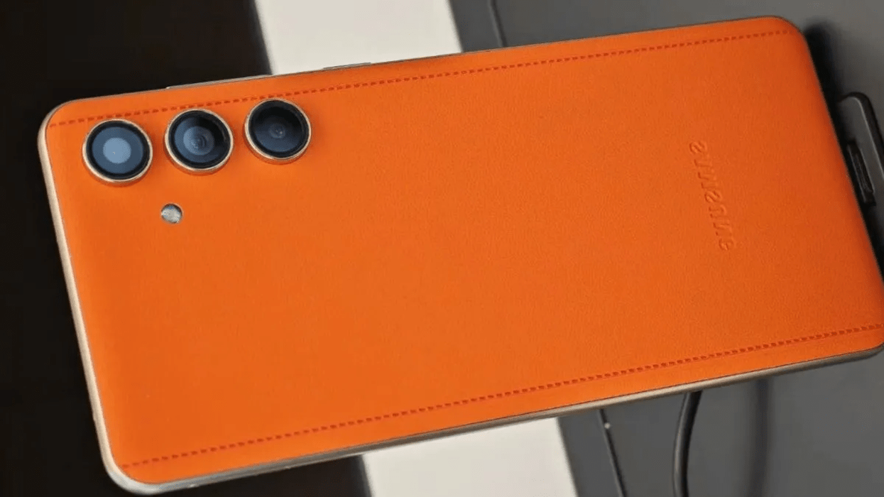 Close-up of the back of an orange Galaxy C55 with three rear cameras in a vertical alignment.